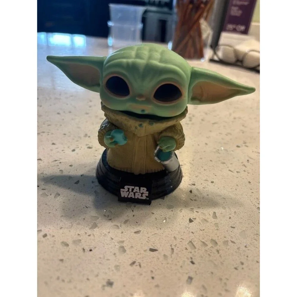 grogu the child eating a cookie star wars funko pop